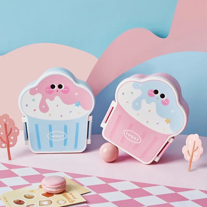 Pink and blue creative ice cream shaped plastic lunch box with compartments, shown with matching spoon and fork.