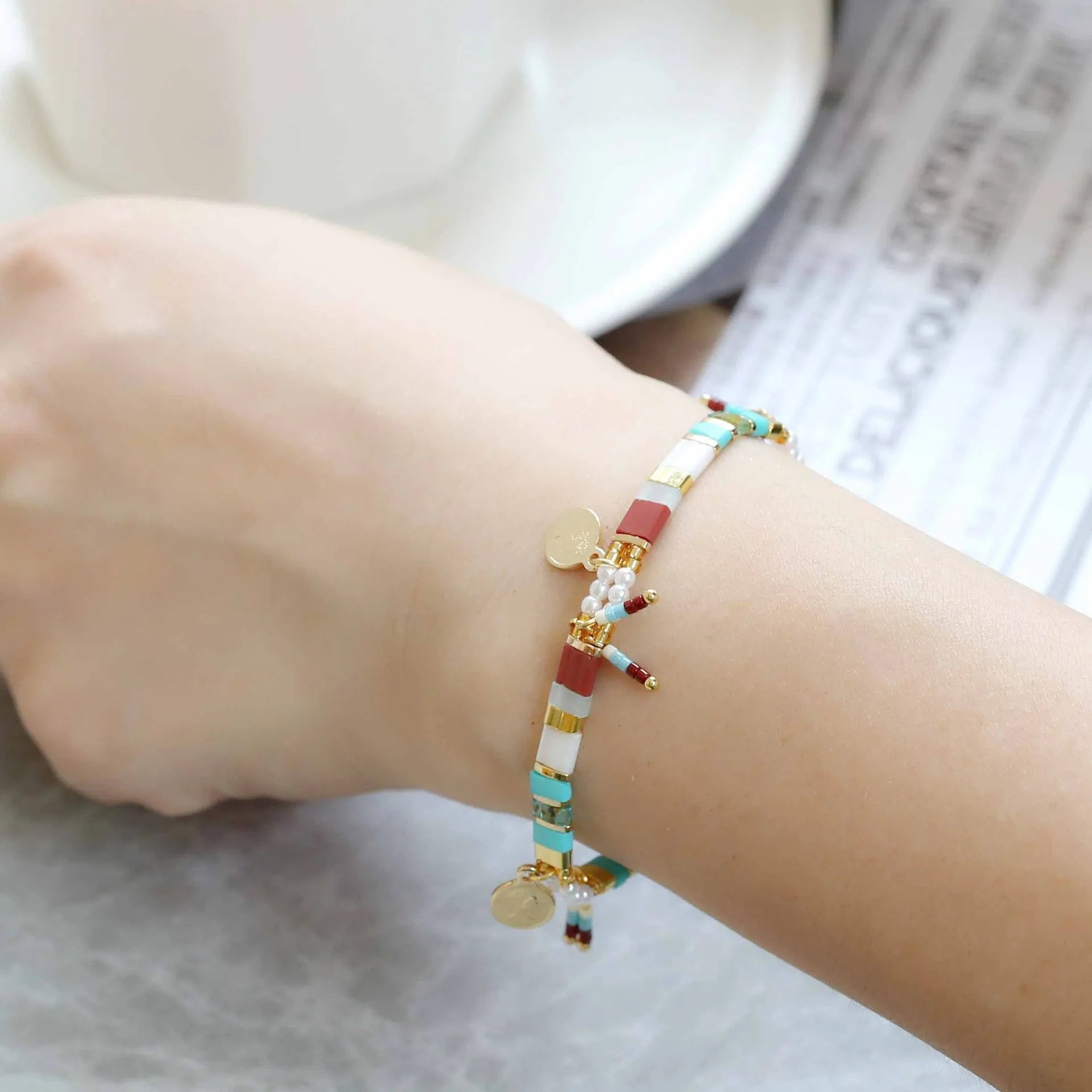 Handcrafted women's bracelet with imitation pearl beads in European style, showing colour variations.