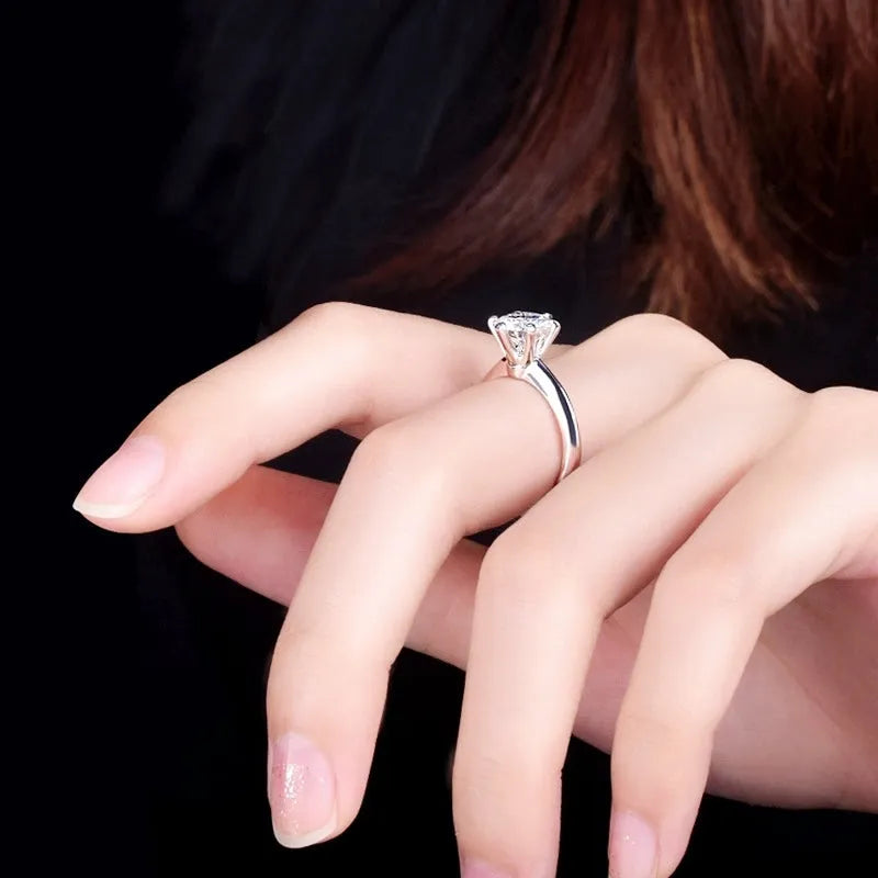 White gold plated geometric ring with a six-claw setting holding a central zircon stone.