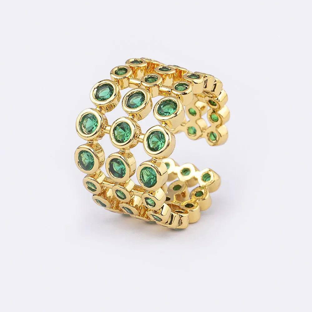Wide gold-coloured ring with large green zircon stone on copper base with gold plating