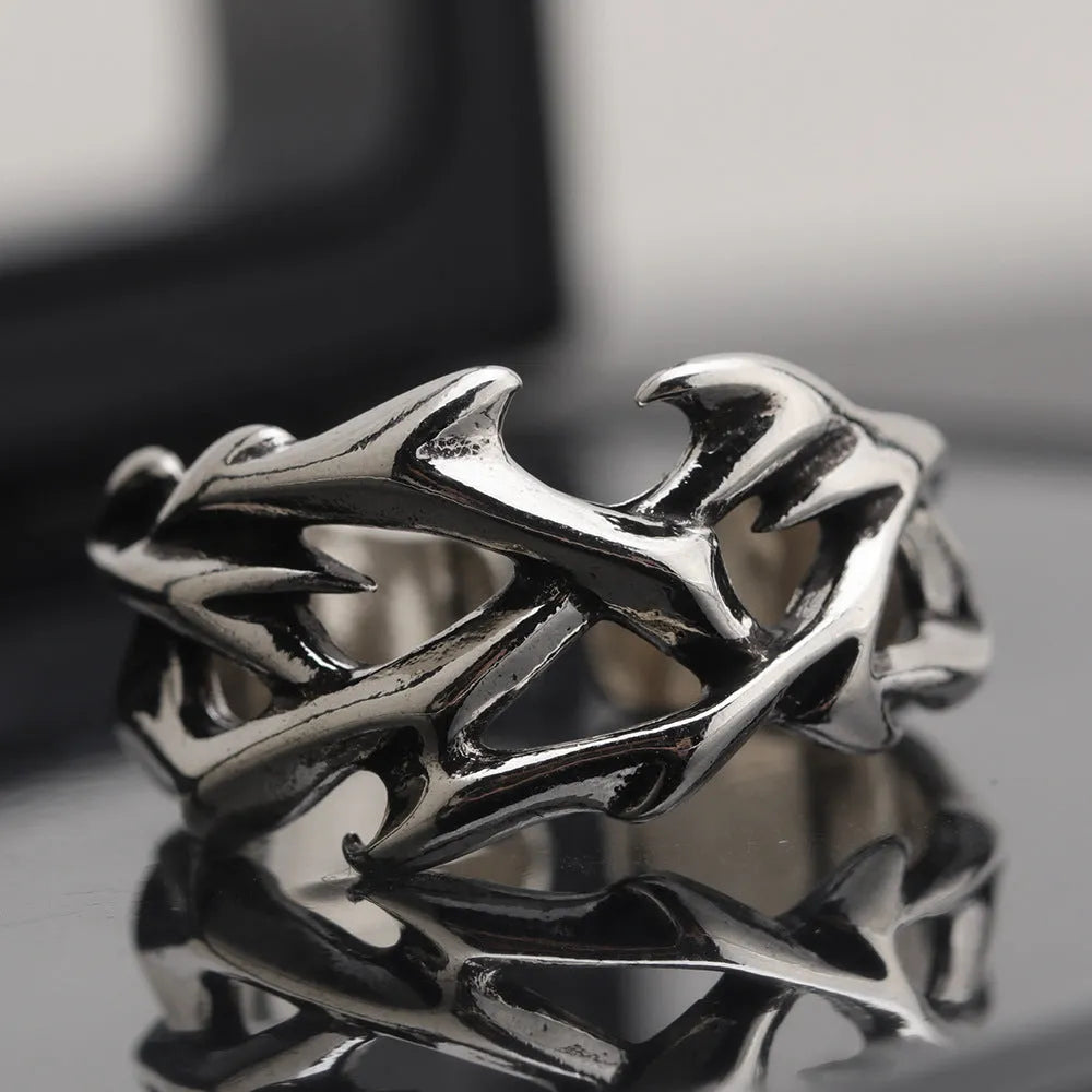 Copper geometric thorn flower ring with adjustable band on a finger, J2150 colour.