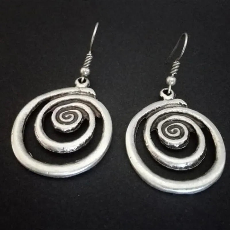 Silver geometric spiral earrings with distressed finish measuring 2.6cm by 5cm