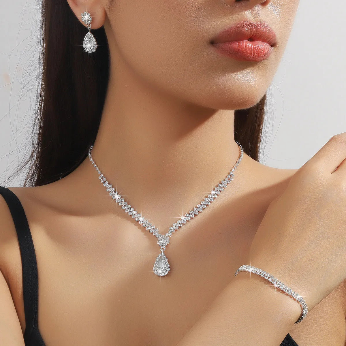 Women's claw chain necklace and earrings set with water drop rhinestones in multiple colour options