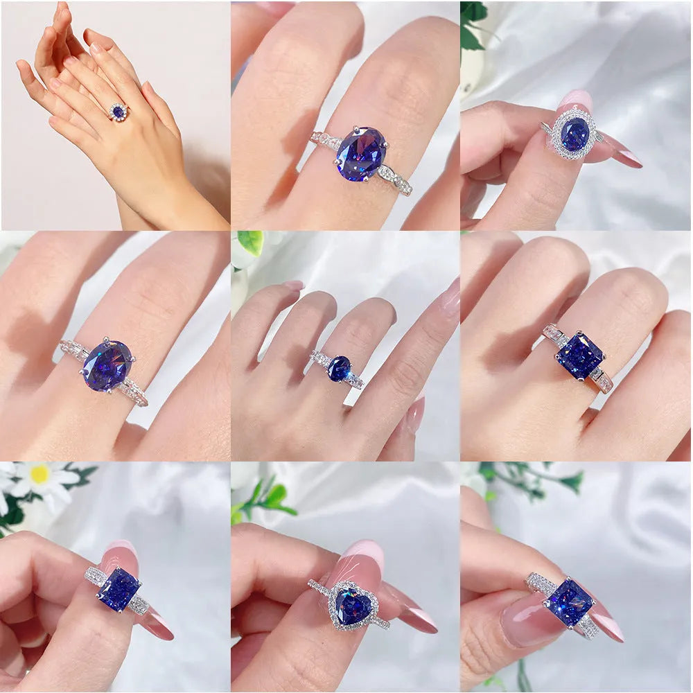 Heart shaped Tanzanite purple zircon ring in sterling silver on a grey background.