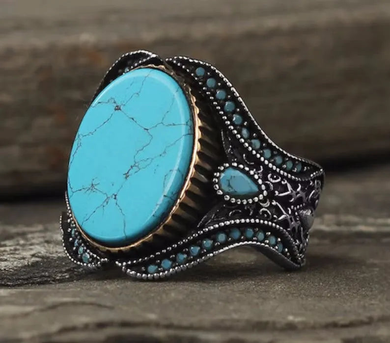Men's antique silver alloy ring with a round design and central turquoise stone.