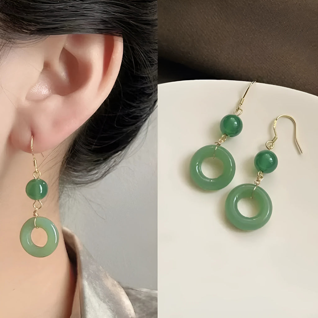 A pair of green geometric peace buckle earrings with a Chinese jade design, made from zinc alloy.