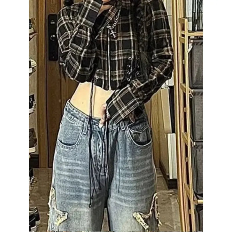 Blue high-waist straight-leg women's jeans on a hanger, showing the front detail and button fastening.