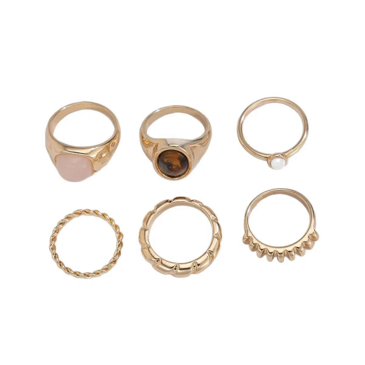 Six geometric alloy rings with irregular designs in light gold colour arranged together