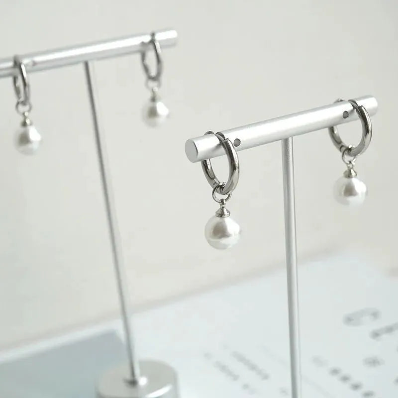 Women's geometric alloy earrings with a round pearl centre and titanium steel post.