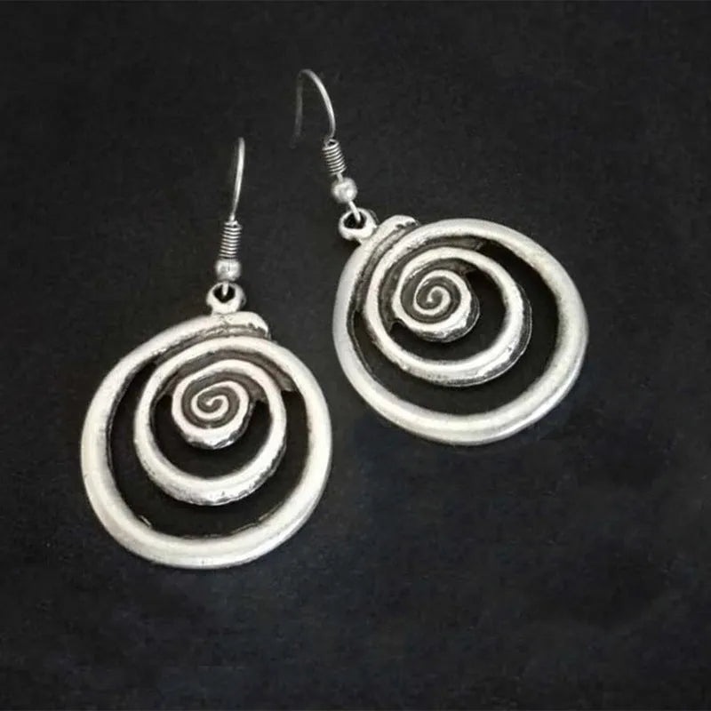 Silver geometric spiral earrings with distressed finish measuring 2.6cm by 5cm