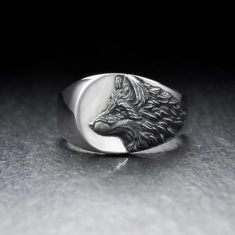 Silver geometric wolf ring for men on a grey background, showing angular retro design.