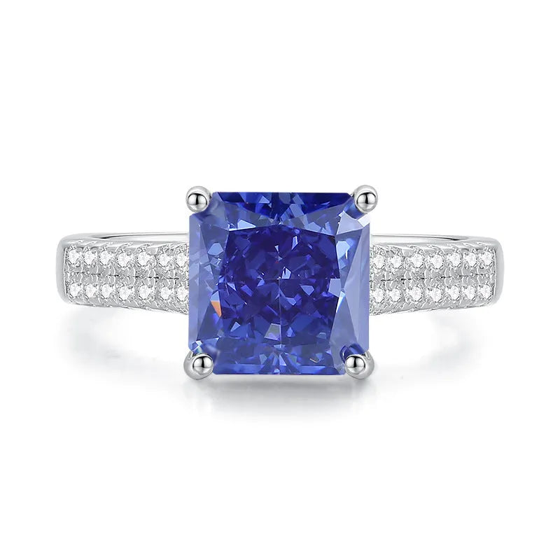 Heart shaped Tanzanite purple zircon ring in sterling silver on a grey background.