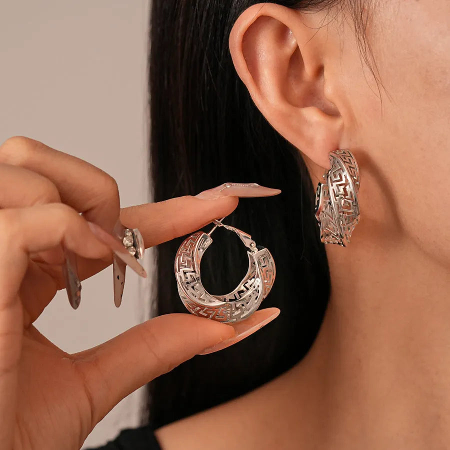 Twisted geometric hollow stud earrings in silver and gold electroplated finishes