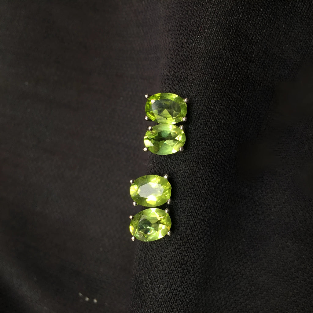 Natural olivine stud earrings with grass green oval stones in sterling silver setting
