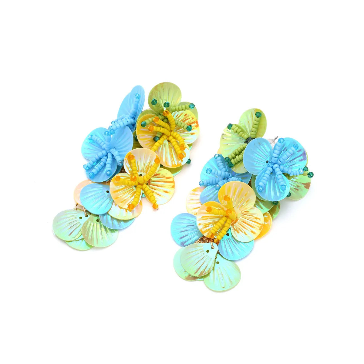 Close-up of handmade colourful bead flower and leaf statement earrings on a white background.
