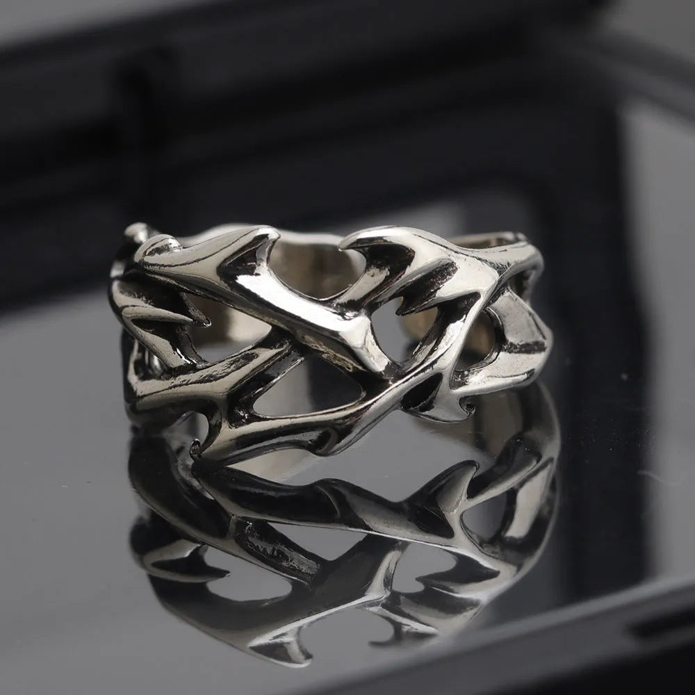 Copper geometric thorn flower ring with adjustable band on a finger, J2150 colour.