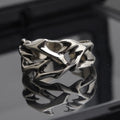 Copper geometric thorn flower ring with adjustable band on a finger, J2150 colour.