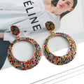 Colourful metal round pendant earrings with diamond design in cartoon style