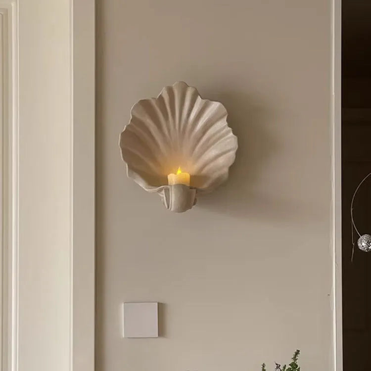 Close-up of a white resin decorative ornament with a detailed seashell design for fruit plates and table displays.