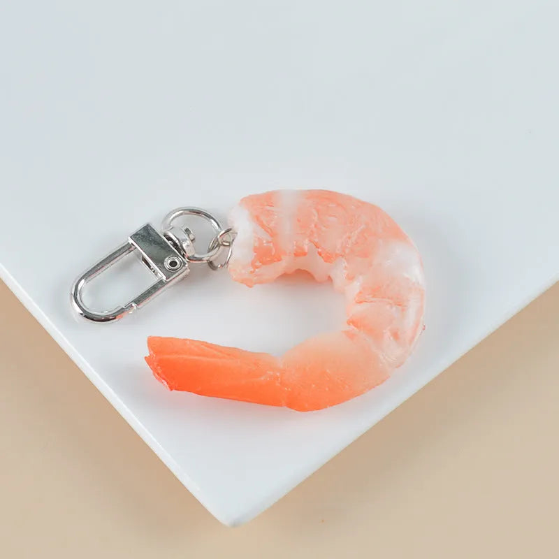 PVC injection moulded shrimp-shaped keychain with modern minimalist design