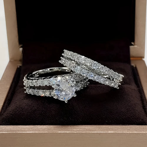 Two geometric women's rings with fully jewelled bands and round cut accents, shown in gold, rose gold, and silver colour options.