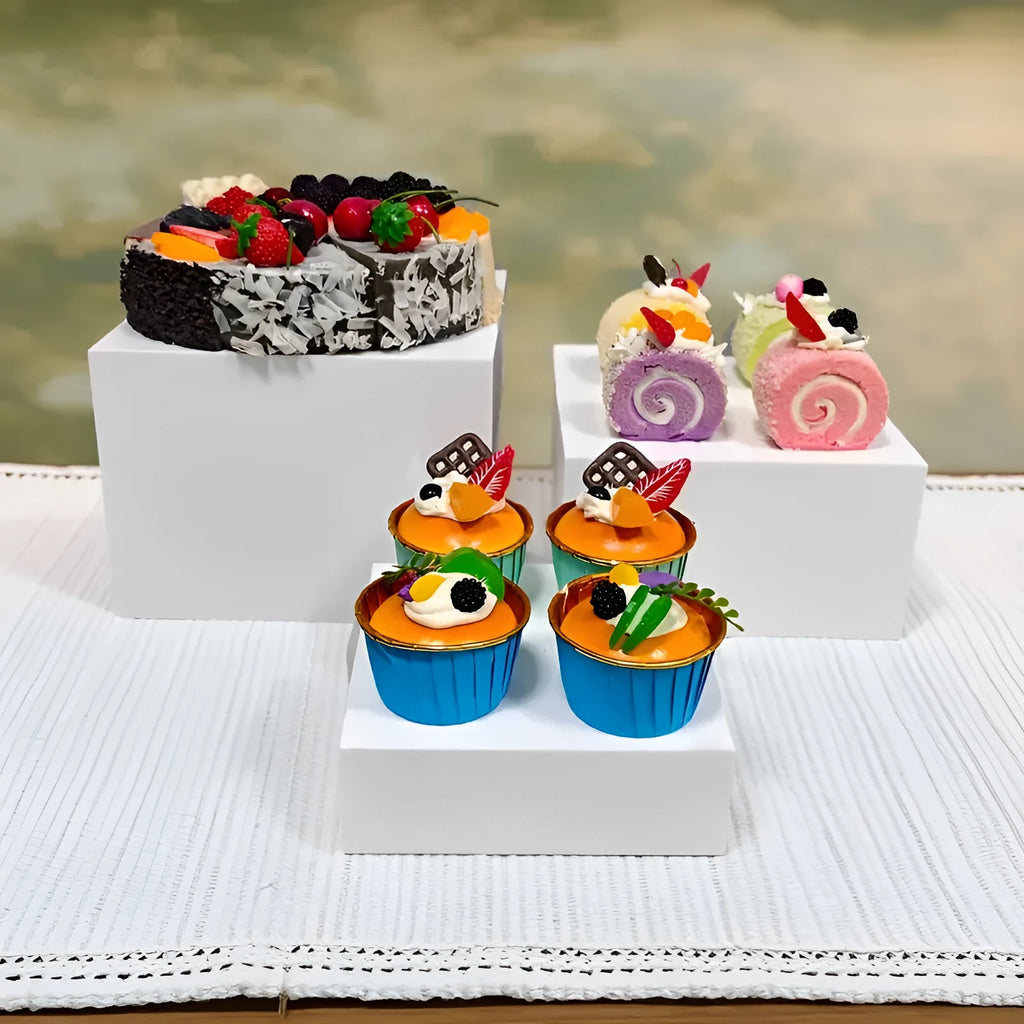 White plastic dessert table display stand with six cube-shaped racks for cakes and pastries.