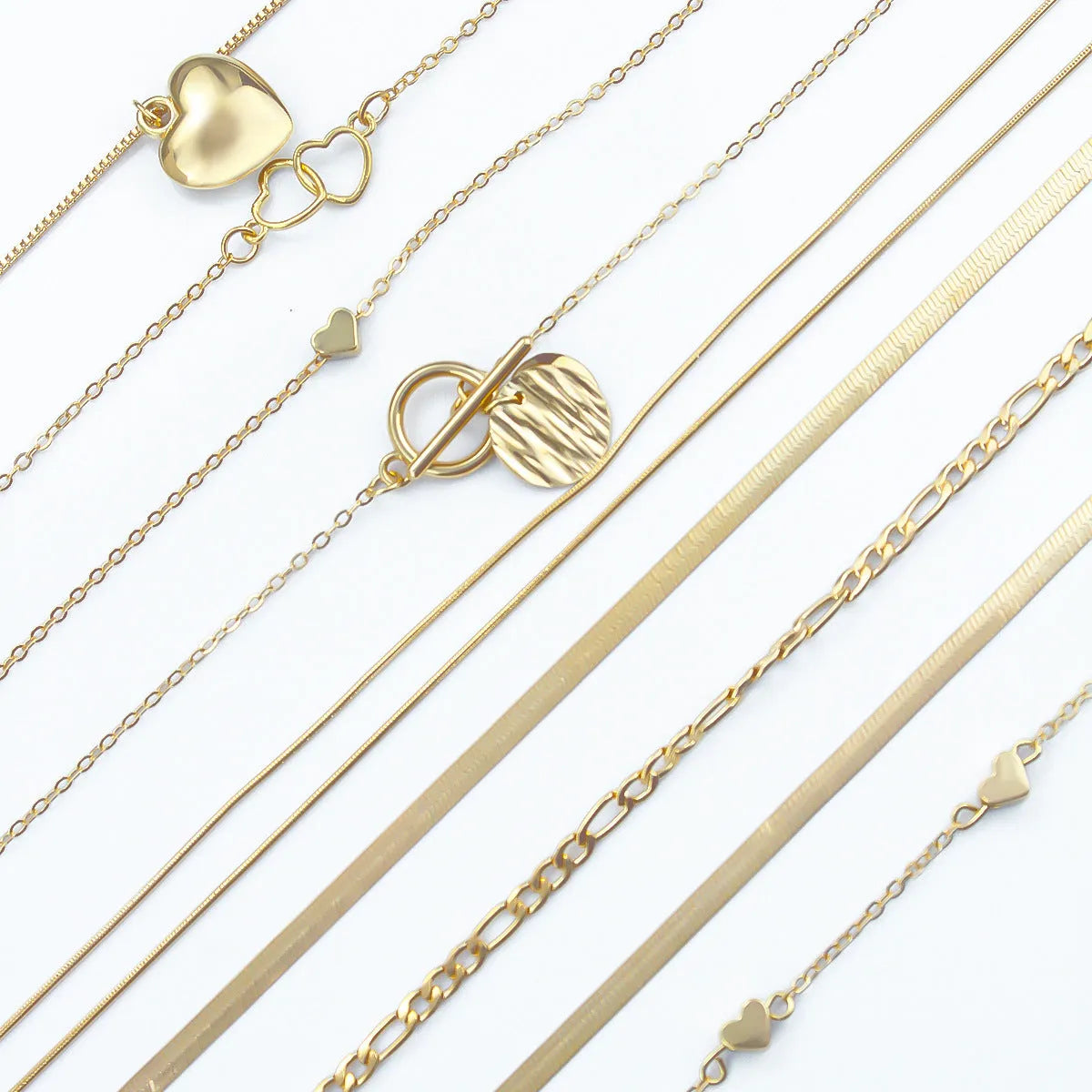 Gold-coloured women's necklace set showing ten pieces with simple alloy pendants on snake bone chains