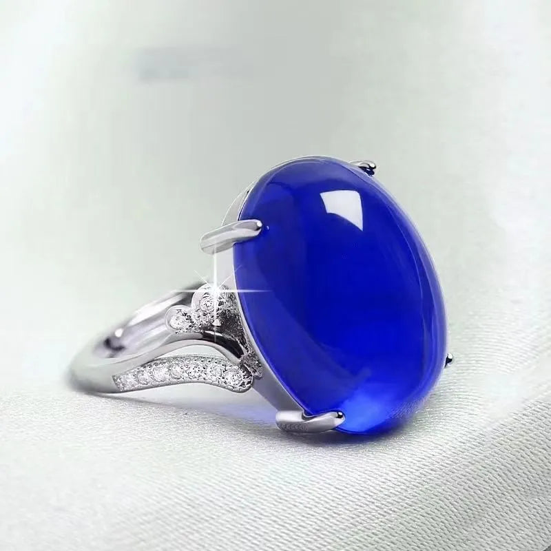 Geometric ethnic style adjustable alloy ring in one of five colours on a plain background.