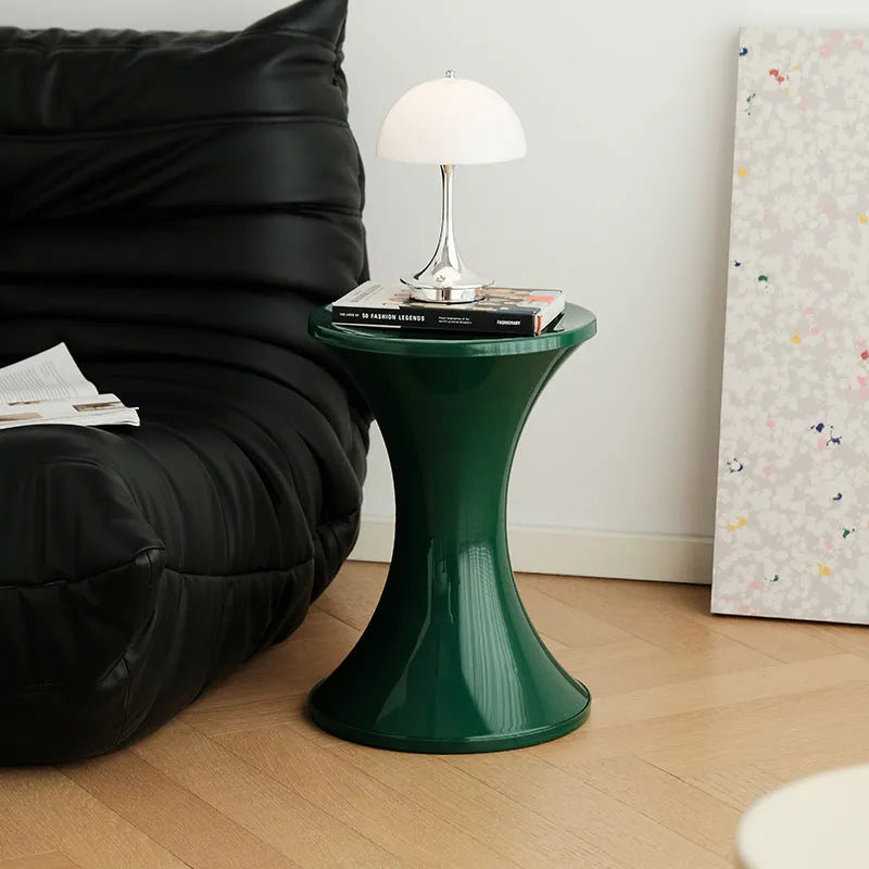 Green plastic hourglass-shaped shoe changing stool for children and adults