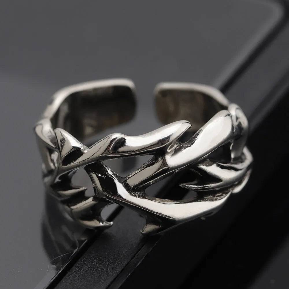 Copper geometric thorn flower ring with adjustable band on a finger, J2150 colour.