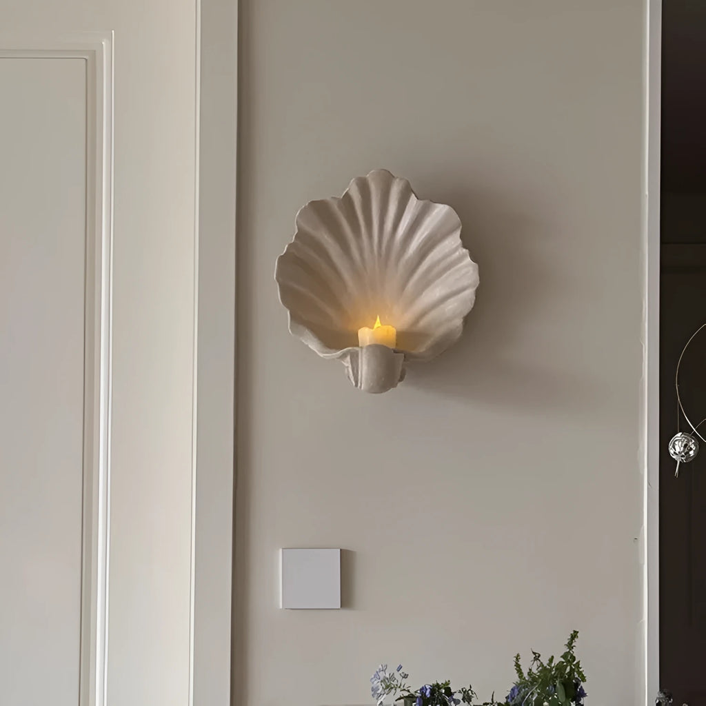 Close-up of a white resin decorative ornament with a detailed seashell design for fruit plates and table displays.