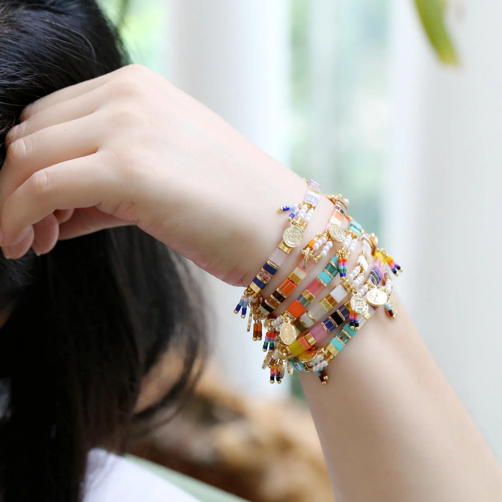 Handcrafted women's bracelet with imitation pearl beads in European style, showing colour variations.