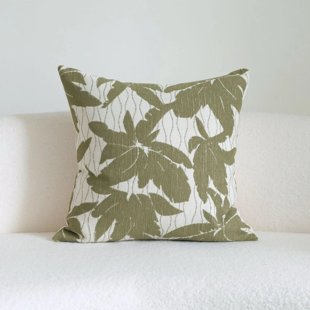 Green cotton and linen hotel sample pillow with tassel details and botanical patterns for display use