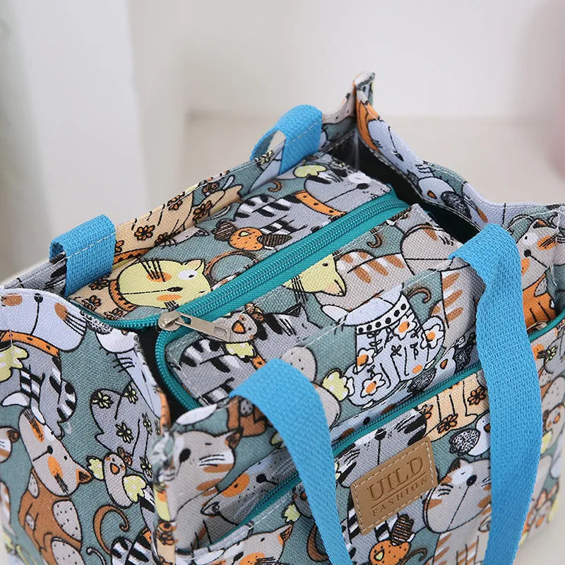 Women's printed canvas handbag with aluminium frame in square horizontal design showing floral pattern