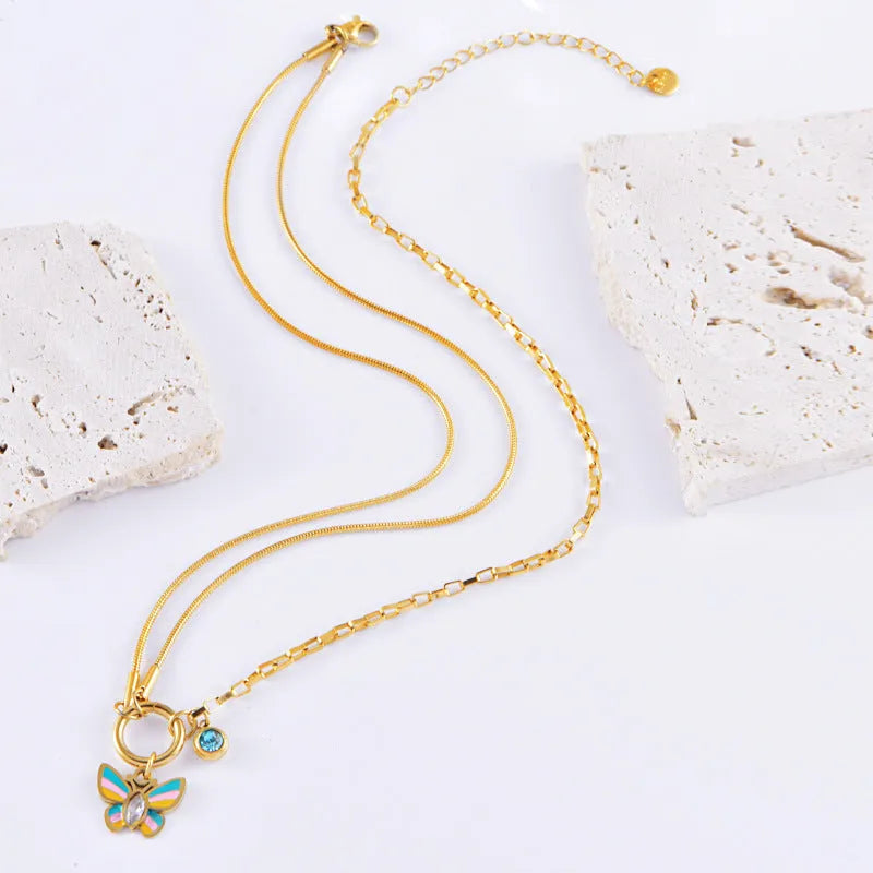 Gold tone epoxy butterfly necklace and bracelet set with snake bone chain.