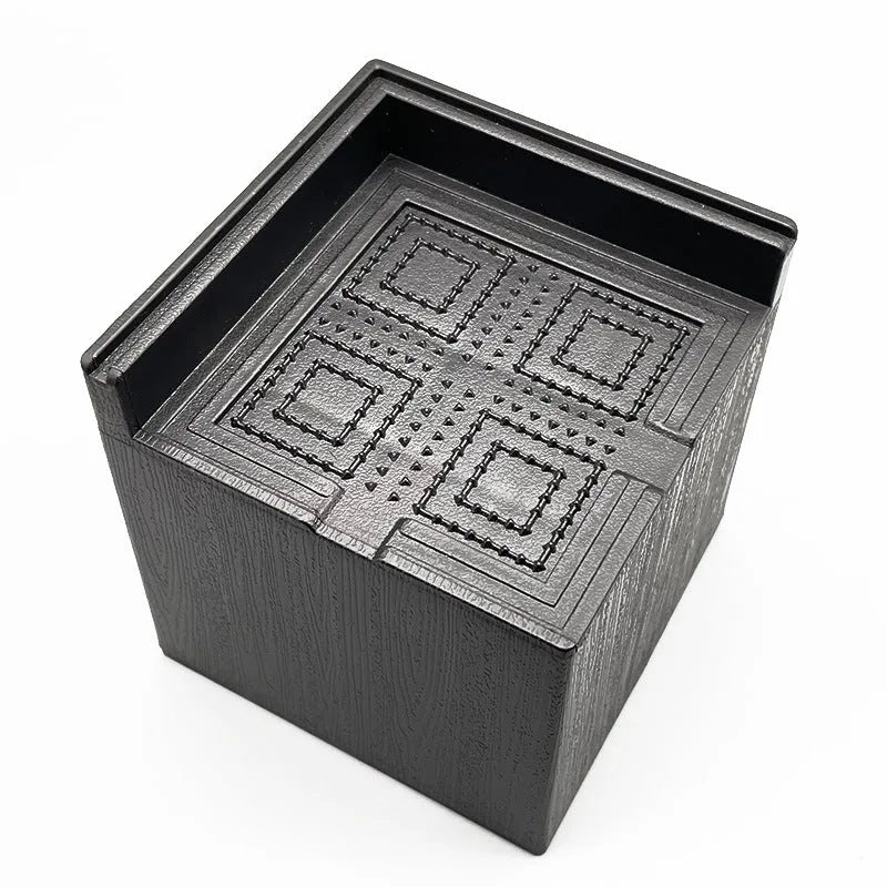 Four black thickened plastic furniture foot mats for height increase and stabilisation