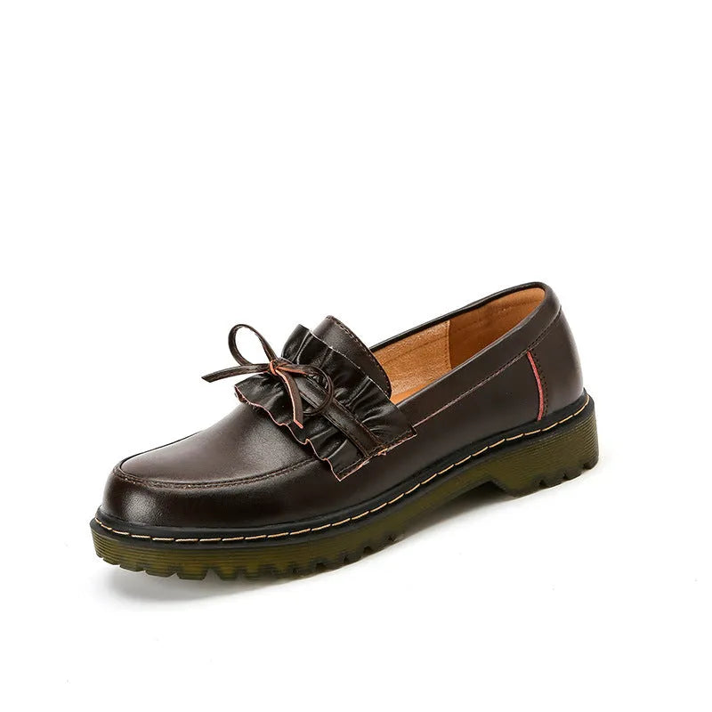Women's black leather shoes with round toe, chunky flat heel, and low-top design on a white background.