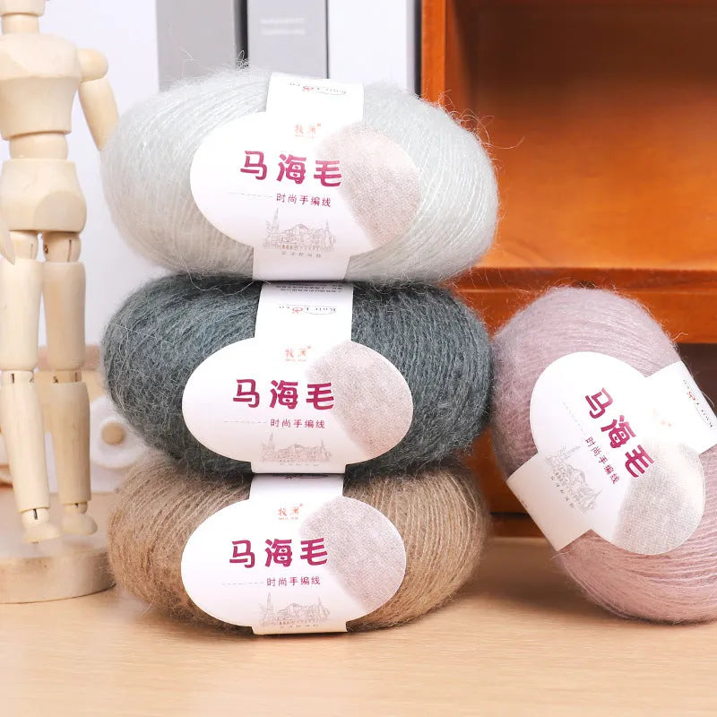 DIY mohair scarf weaving kit showing one wool ball and a selection of 34 colour options including white, pink, blue and green.