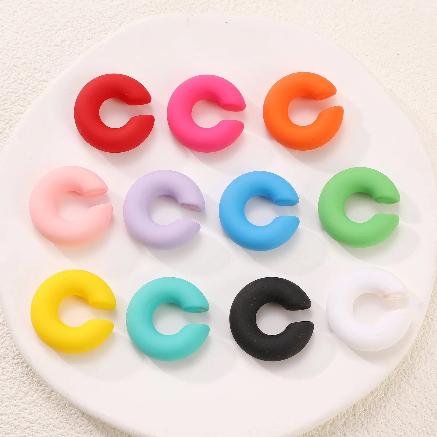 Matte coarse round C-shaped clip-on earrings in a selection of candy colours for women, no piercing required.