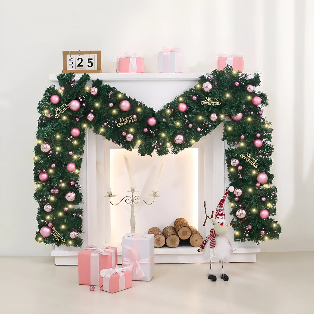 Pink artificial rattan Christmas garland with small fruit details and warm white LED lights, coiled to show its 2.7m length.