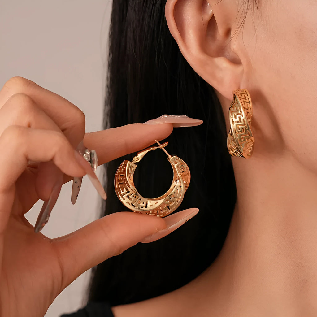 Twisted geometric hollow stud earrings in silver and gold electroplated finishes