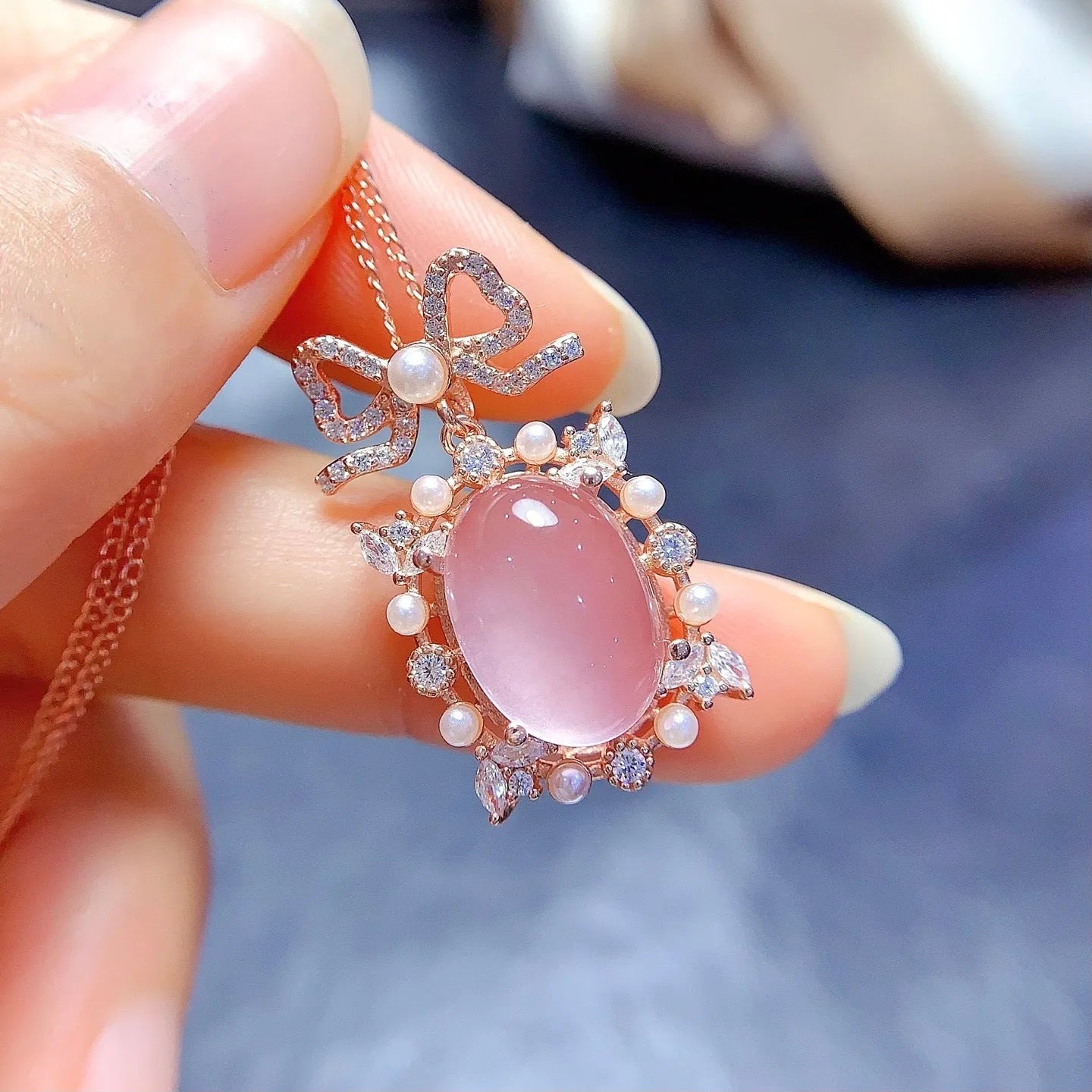 Rose gold plated geometric silver necklace with a pink rose quartz crystal pendant.