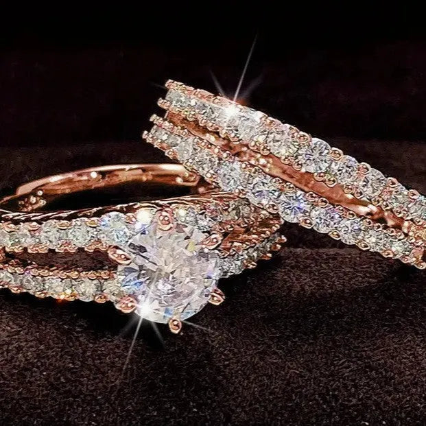 Two geometric women's rings with fully jewelled bands and round cut accents, shown in gold, rose gold, and silver colour options.