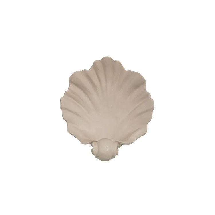 Close-up of a white resin decorative ornament with a detailed seashell design for fruit plates and table displays.