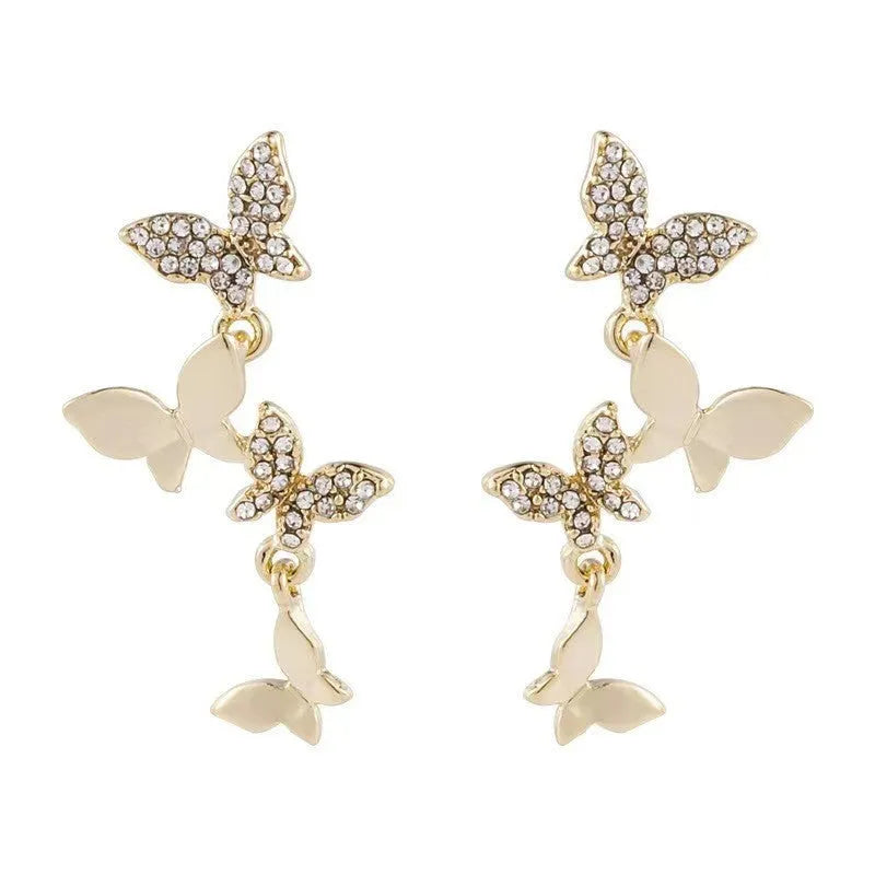 Women's gold colour copper butterfly drop earrings showing four hinged elements