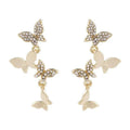 Women's gold colour copper butterfly drop earrings showing four hinged elements