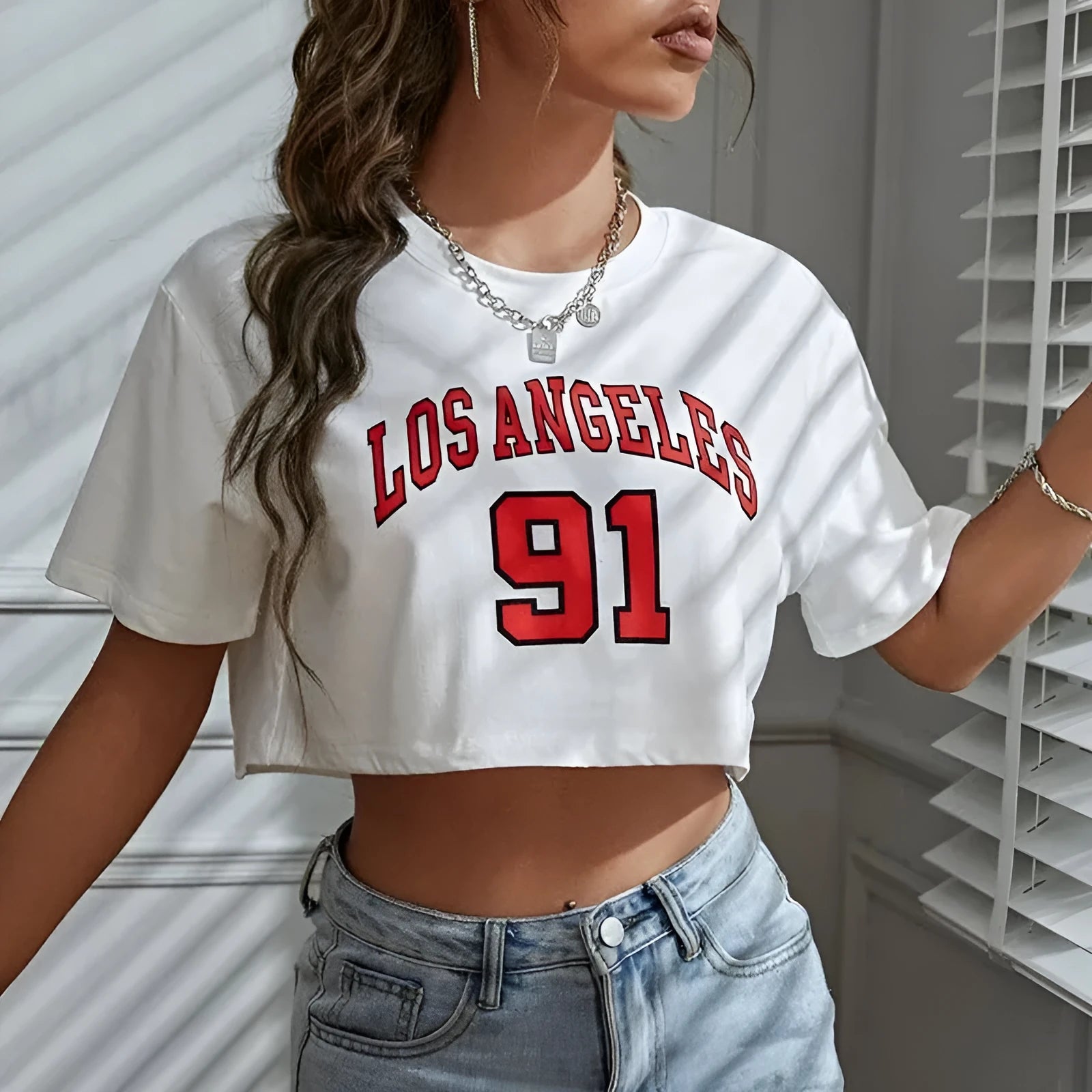 A loose-fit black cotton t-shirt with printed white English letters and an exposed navel design.