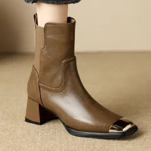 Women's brown cowhide leather Martin boots with a high heel and side zipper on a white background.