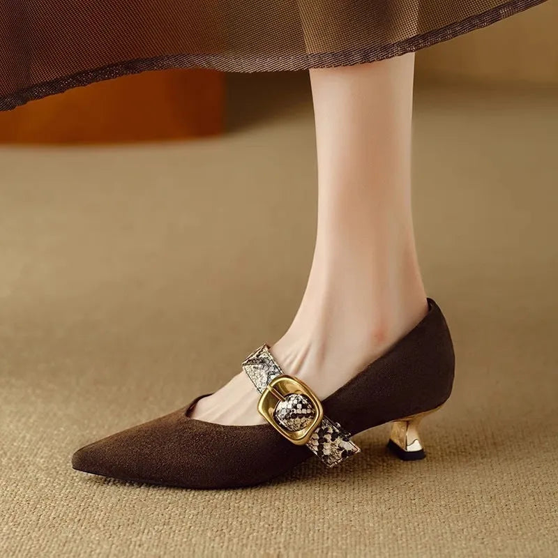 Women's black pointed-toe stiletto heels with a buckle fastening and mid-height heel.