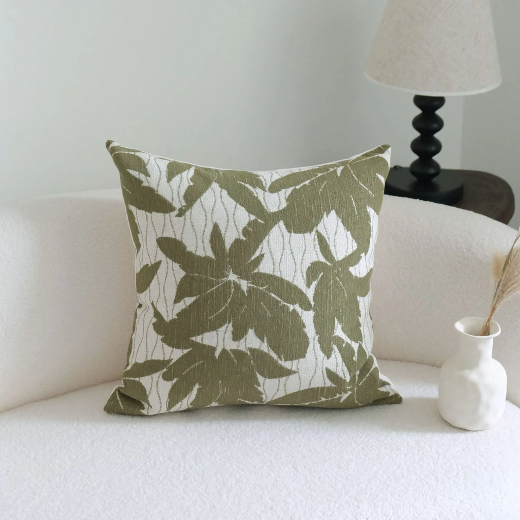 Green cotton and linen hotel sample pillow with tassel details and botanical patterns for display use